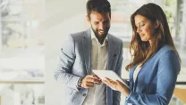 Man and woman looking at a tablet