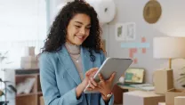 Business woman using a tablet in a small business logistics centre