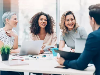 Four colleagues in a business meeting with printed documents